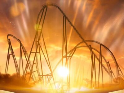 Silhouette of Thorpe Park rollercoaster at sunset with radiant sky and light beams